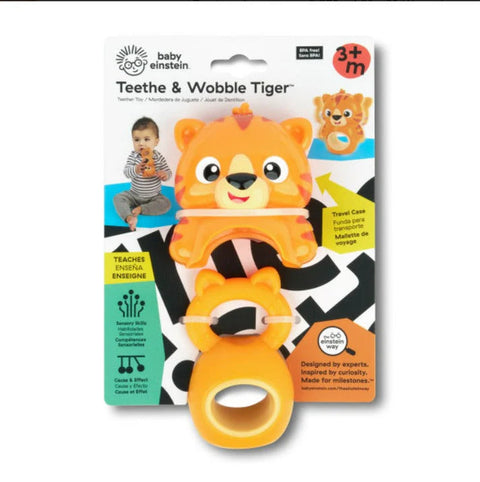 The Baby Einstein Teethe & Wobble Tiger Teether Toy is displayed in its packaging, featuring an image of a baby holding the teether and various product details. This teether with a handle promotes sensory exploration and is suitable for babies aged 3 months and up.