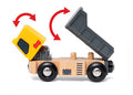 The Brio World Construction Vehicle, produced by Brio, is a wooden toy dump truck featuring a yellow cab and a gray dump bed that can tilt as demonstrated by red arrows. With four black wheels displaying gray centers, this construction vehicle is ideal for roleplay adventures.