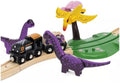 The Brio World Dinosaur Adventure Set by Brio is a whimsical play set featuring a black engine and two dinosaurs on wooden tracks, surrounded by toy dinosaurs. Two purple ones and a yellow pterodactyl perched on a green stand complete this colorful train set with dinosaurs.