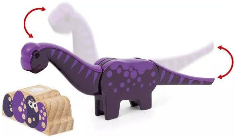 A purple and black toy dinosaur with a movable neck is shown. The toy's head can swing forward and backward, as indicated by red arrows. It sits next to a small, colorful block with circular patterns, part of the exciting Brio World Dinosaur Adventure Set from Brio.