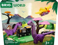 Box of the Brio World Dinosaur Adventure Set. The front showcases a toy train with a black engine and white carriages traveling through a prehistoric landscape featuring green tracks, two purple dinosaurs, orange-and-purple trees, and a yellow flying pterodactyl in this thrilling dinosaur-themed playset.