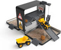 The CAT Little Machines Store-n-Go Playset by CAT features a black and grey play structure with ramps, a crane, caution signs, and a sandbox. It includes two yellow toy dump trucks positioned on the structure and brown toy rocks scattered in the sand. This playset is designed for easy clean-up with its portable storage system.