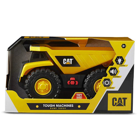 A yellow and black CAT Tough Machines Lights/Sounds - Dump Truck is displayed in a box. The packaging highlights realistic flashing lights, engine revving sounds, and rumble effects. Text states "Tough Machines Dump Truck," and a "Try Me!" button is visible. Suitable for ages 3+.