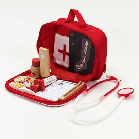 The Classic World Doctor Case by Classic World is opened, revealing various items inside. The kit includes a stethoscope, syringe, wooden thermometer, medication bottles, clipboard with paper, bandages, and an X-ray image of a leg. Perfect for roleplay scenarios, the interior features a red cross symbol on a white background.