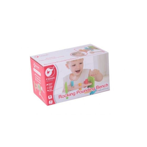 A red and white box shows a smiling child playing with the "Classic World Rocking Pounding Bench," a toy designed to enhance hand-eye coordination. Crafted from natural wood, it includes colorful pegs and a mallet. The Classic World logo is prominently displayed on the box.