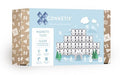 A box of Connetix Clear Rectangle Pack 12pc is displayed. The light blue background features snowy graphics and illustrations of children engaged in STEAM learning. It contains a 12-piece pack of clear rectangles, ideal for ages 3+.