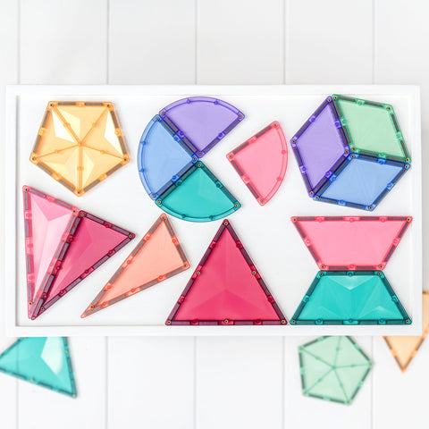 A set of colorful magnetic tile shapes arranged on a white surface. The Connetix Pastel Shape Expansion Pack 48pc by Connetix includes various geometric shapes like triangles, squares, a half-circle, and a pentagon in vibrant colors such as yellow, blue, purple, red, and green.