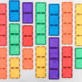 An 18-piece assortment of rectangular magnetic tiles from the Connetix Rainbow Rectangle Pack is arranged in a grid pattern. This set, an open-ended toy by Connetix, features tiles in bright colors such as blue, orange, red, yellow, green, and purple, creating a vibrant and playful visual.