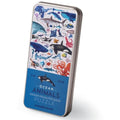 A rectangular metal tin from Crocodile Creek contains a 150-piece puzzle titled "Ocean Animals." The tin's lid features vibrant illustrations of various marine creatures, including sharks, whales, and fish. The bottom of the lid is labeled with "Ocean Animals Puzzle" and the brand name, Crocodile Creek.