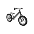 The Cruzee Balance Bike - Black features a minimalist design with robust black tires, white rims, and black handlebars. It boasts an ultralight frame without pedals, which is adjustable in size making it ideal for young children learning to balance. The brand name "Cruzee" is prominently displayed on the frame.