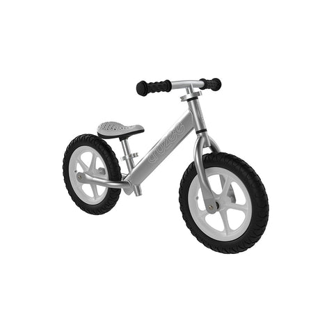 The Cruzee Balance Bike - Silver by Cruzee features black knobby tires and black handle grips. It has no pedals and is designed for young children to develop balance and coordination. The seat and frame are silver, featuring size adjustability for growing kids, while the bike boasts a minimalist design.