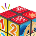 Close-up view of a colorful, educational activity toy cube for toddlers featuring different learning elements on each side. The Fisher-Price Laugh & Learn Puppy's Activity Cube includes sections labeled "123" and "ABC," with raised dots for tactile engagement and illustrations of numbers and a cute character with blue ears.