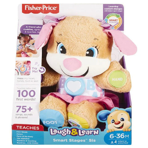 Image of the Fisher-Price Laugh & Learn Smart Stages Sis musical plush toy in its packaging. This beige dog baby learning toy, featuring pink ears, a pink skirt, and patches on its paws labeled "Hand" and "Foot," is designed by Fisher-Price. The box highlights that the toy plays over 75 songs, sounds, and phrases for children aged 6-36 months.