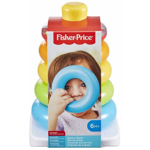 A baby plays with the Fisher-Price Rock-A-Stack toy, holding a large blue ring in front of their face. The colorful rings of this classic stacking toy, featuring vibrant red, orange, yellow, green, and blue hues produced by Fisher-Price, are stacked on a white base. The packaging is marked "6M+.