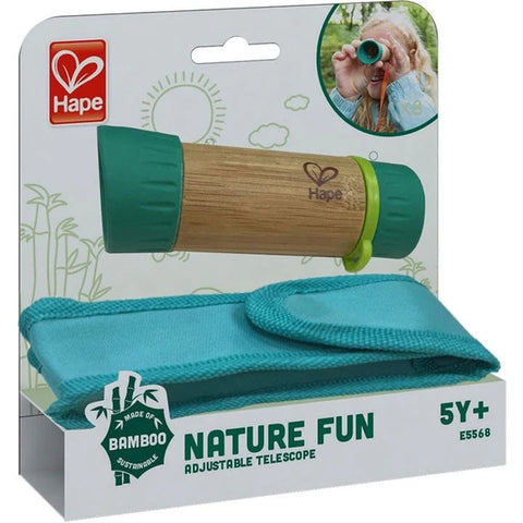 Packaging for the Hape Adjustable Telescope by Hape, suitable for ages 5 and up. The set includes a green-colored telescope, perfect for bird watching, and a teal carrying case. The background features a child using the telescope and text highlighting its eco-friendly bamboo construction.