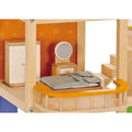 The Hape All Season Doll House Furnished by HAPE features a wooden dollhouse bedroom with a striped bed and a green pillow situated on an orange balcony. The room includes a small dresser with a mirror, a white wardrobe, and moveable stairs leading upward. The bright orange walls are adorned with flower patterns. As part of the four-room sets, this delightful dollhouse boasts a solar-panelled roof.