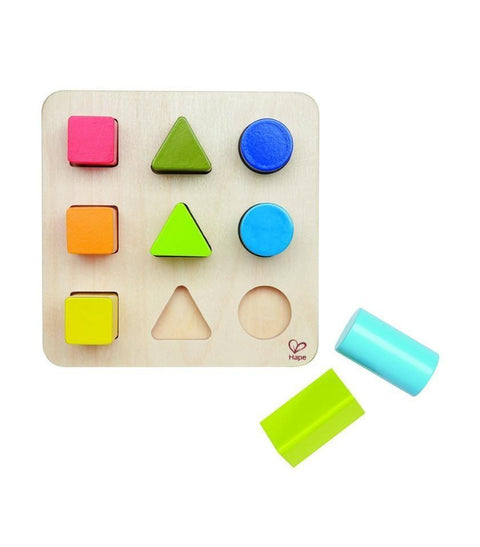 The Hape Color and Shape Sorter by Hape is a wooden toy board designed for sorting and color and shape identification. Each row features a different shape—square, triangle, and circle—in various colors such as pink, green, yellow, blue, orange, and more. Some shapes fit into designated slots while others are positioned beside the board.