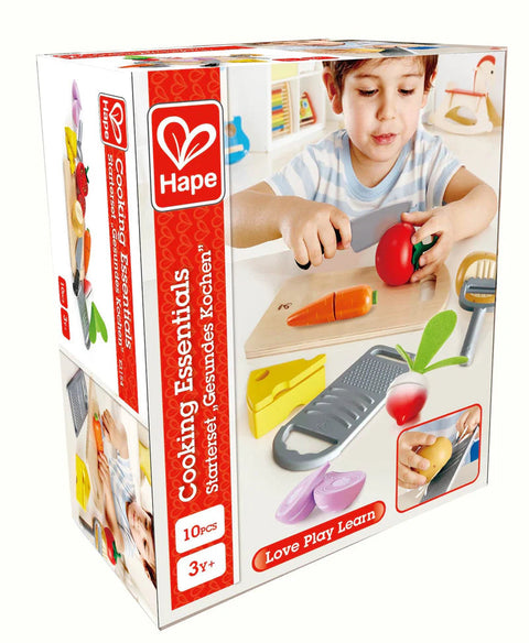 The vibrant packaging of Hape's Cooking Essentials playset, designed for children aged 3 and up, features a child engaged with toy vegetables, a toy cutting board, and a grater. This 10-piece set encourages learning through play under the tagline "Love Play Learn.