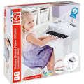 A young child sits at a small, white toy grand piano, pressing the keys and smiling. The box indicates the product is a Hape Deluxe White Grand Piano for ages 3 and up, featuring 30 keys and includes a music book. Ideal for crafting mini symphonies, it carries the tagline "Love play. Learn." visible on the packaging.