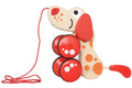 Hape Pepe Pull Along by HAPE is a popular gift. This wooden interactive pull-along toy is shaped like a puppy pal with orange spots and red floppy ears. The dog's legs are represented by two red wheels with white dots, and a red string is attached to the front for pulling.