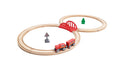 Experience the ultimate railway adventure with the Hape Play Essentials Classic Figure 8 Set. Featuring a simple track layout of two connected loops, it includes a red bridge, green tree, railroad crossing sign, and a red toy train with an engine and one carriage reminiscent of Hape railway sets from the renowned brand Hape.