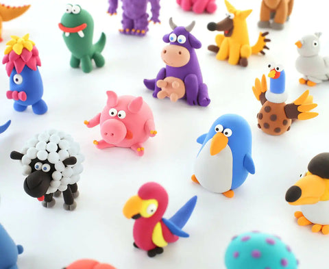 A vibrant assortment of colorful clay animal figures arrayed on a white background, showcasing characters like a pig, sheep, penguin, parrot, dinosaur, and cow among other whimsical creatures. Each figure is crafted in lively colors and delightful designs using the Hey Clay 15 pack - Animals by Hey Clay for play-based learning.