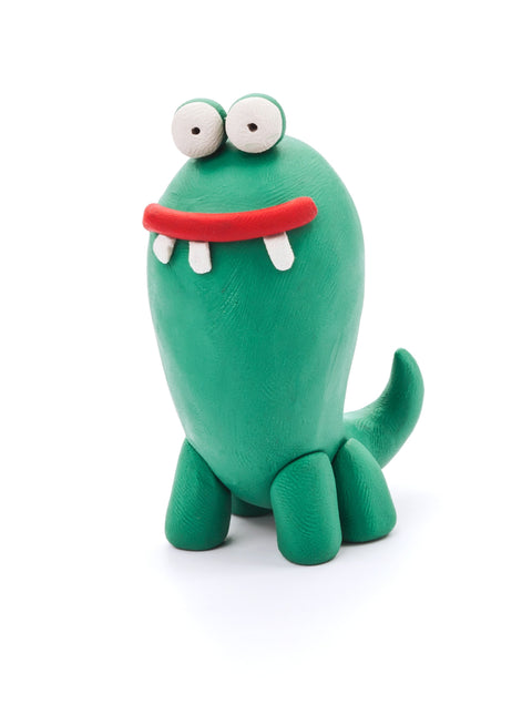 A lively green dinosaur made from the Hey Clay 6 pack - Monsters (Cyclops, Terry, Pi) by Hey Clay showcases large, round eyes, a wide red mouth, and two striking white teeth. Its simple upright body with short legs and a small tail is set against a white background.