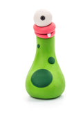 A whimsical green clay monster resembling a potion bottle with large dark green spots. Crafted from the Hey Clay 6 pack - Monsters (Cyclops, Terry, Pi) by Hey Clay, it features a pink, rounded mouth with a single visible tooth and a large, single eye perched on top, giving it a quirky and comical appearance perfect for play-based learning.