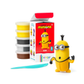 A Hey Clay Single Pack Minions - Kevin activity set, which includes tubs of soft modeling clay and a plastic sculpting tool, sits beside an open box, showcasing a completed yellow Minion wearing goggles and blue overalls. This fun project by Hey Clay is perfect for enhancing fine motor skills.