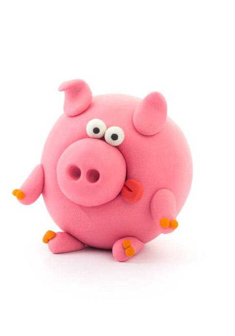 A charming pink clay pig figurine from the Hey Clay Single Pack - Piggy by Hey Clay features big round eyes, a wide snout, and small curled ears. The pig has an orange nose and tiny orange feet, sitting upright against a plain white background. Perfect for sensory development!