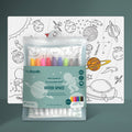 Displayed is a Hey Doodle Silicone Playmat - Outer Space (Large), featuring open-ended drawing prompts such as planets, spaceships, and astronauts meant to be colored. In front of the mat, there's a package of colorful markers labeled "Hey Doodle Reusable Silicone Mat: Outer Space.