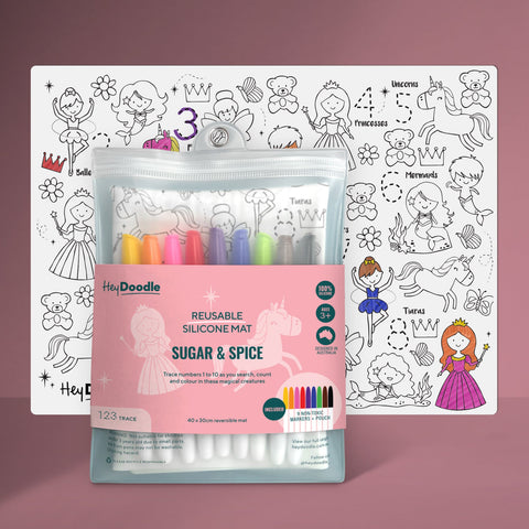 The Hey Doodle Silicone Playmat - Sugar & Spice (Large) from Hey Doodle is a reusable mat with a laminated design that includes outlines of princesses, unicorns, stars, hearts, and other whimsical elements. The package in front contains colourful markers and the playmat itself.