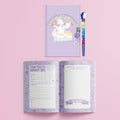 The Hinkler Journal Kit - Super Sweet by Hinkler includes a purple unicorn-themed lockable journal with "Chase the Rainbow" on the cover, accompanied by a unicorn pen. When you open the journal, you'll find pages titled "Fun Facts About Me" and "My Family," each featuring creative prompts. The background is pink.