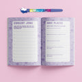 Description: The Hinkler Journal Kit - Super Sweet features an open journal with pages labeled "Coolest Jobs" and "Fave Places" set against a pink background. Included is a colorful unicorn pen, placed horizontally above the journal, which boasts a vibrant purple and white patterned design. This set by Hinkler is perfect for jotting down creative prompts.