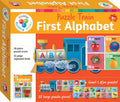 The image showcases a colorful box for the "Hinkler Puzzle Train - First Alphabet," an alphabet puzzle ideal for early learning and suitable for ages 3+. It features illustrations of a train with alphabet blocks, including the letters A, B, and N, along with corresponding images of an apple, ball, and nest. The set includes 28 pieces and a 16-page book.