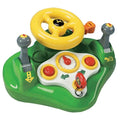 The John Deere Busy Driver by John Deere is a colorful toy featuring a green base with various interactive components, including a yellow steering wheel, two gray levers with red buttons, a red ignition key, a red dial button, and a white section with a simulated speedometer. It also includes realistic sounds for added fun.