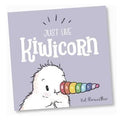 The Kiwicorn Mini Board Book, part of the KUWI THE KIWI brand, features a children's book cover illustrated with a fluffy creature sporting a colorful spiral horn. The title "Just Like Kiwicorn" is displayed in large, whimsical font, with Kat Merewether’s name beneath it. A light purple background sets the perfect tone for this delightful tale that promotes diversity teaching.