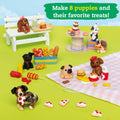 In a playful display, the Klutz Mini Clay World: Puppy Treat Truck features an assortment of adorable clay puppies and their favorite treats. Some of the cute figures are sitting on a white bench, while others are spread out on a picnic blanket with delightful food items like hot dogs, cupcakes, and bones. The text above reads, "Make 8 clay puppies and their favorite treats!