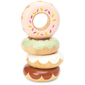 A stack of four Le Toy Van Doughnuts, crafted by LE TOY VAN from solid wood and artfully decorated with varying frosting colors and sprinkles, are neatly packaged in a window gift box. These charming donuts feature pink, light green, white, and brown frosting from top to bottom, each designed with a hole in the center and a scalloped edge.