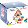 A box labeled "Le Toy Van Little Bird House Shape Sorter" by LE TOY VAN. The box features an illustration of a colorful birdhouse-shaped toy made from sustainable wood, assorted geometric shapes, and is marked for ages 1-2 years. The packaging is blue with playful animal images at the bottom.