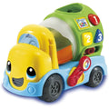 Introducing the Leapfrog Popping Colour Mixer Truck by Leapfrog: a vibrant mixer truck with a yellow cabin, smiling face, and blue wheels. Its green mixing drum has holes labeled 1, 2, and 3 in various colors. This engaging toy features construction sounds and includes a red lever on the side for sorting geometric shapes.