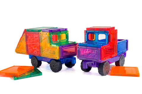 Two vibrant toy trucks crafted from interlocking transparent magnetic tiles in an array of colors such as red, blue, purple, yellow, and green. The trucks are set against a white background with several loose tiles scattered nearby. These vehicles are part of the Learn & Grow Rainbow Magnetic Tiles Car Expansion Pack 28pc by Learn & Grow and come equipped with rubber wheels for seamless play.