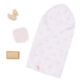 The Lullababy 14" Outfit - Bath Time with Accessories by Lullababy includes a charming set featuring a white baby hooded towel adorned with pink stars, a beige washcloth, a rubber duck with a gold crown, and a tan bristle brush, all beautifully displayed on a white background.