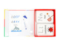 The MIEREDU Wipe Clean Activity Set - Letters by MIEREDU includes a foldable board featuring the letter 'D', a marker, and wipe-clean cards that present the letters 'N' and 'L'. Accompanying the letter 'N' is an illustration of a net, while beside the letter 'L' is a picture of a ladybird—ideal for improving literacy skills through engaging letter tracing activities.