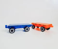 Two toy vehicles from the Magblox Twin Car Set by Magblox are shown against a plain white background. The vehicle on the left is transparent blue with black wheels, and the one on the right is transparent orange with black wheels. Both toys feature simple, blocky designs that fit perfectly with magnetic car bases for creative play.