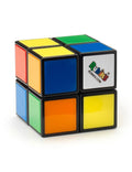 The Rubiks 2x2 Mini by Planet Fun boasts a smoother mechanism and features various colored squares such as orange, yellow, blue, green, red, and white arranged on a black plastic framework. The white face displays the Rubik's logo in a multicolored font.