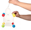 A pair of hands are holding a geometric structure made of clear plastic rods and multicolored ball connectors from the Sick Science Big Bubble Blast^. A bulb pipette is being used to add the bouncing bubble solution to the structure, likely for a scientific or educational demonstration by Sick Science.