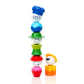 Five vibrant toy pieces are stacked vertically, with a sixth piece positioned next to the stack. The SmartMax My First People set, by SmartMax, includes pieces adorned with various facial expressions and hats that resemble playful, cartoonish characters.