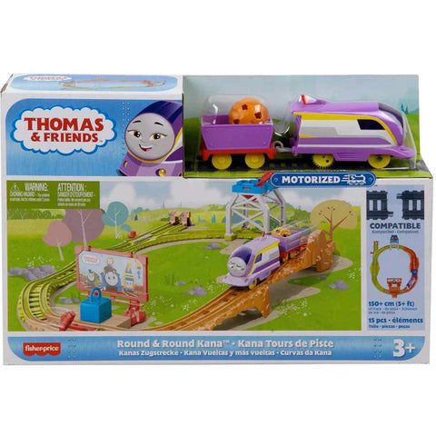 The image shows a boxed Fisher-Price toy set called "Thomas & Friends Motorized Engine - Round & Round Kana." The set includes a motorized train, tracks, and various accessories. The packaging displays colorful illustrations of the toy in action, indicating it is suitable for ages 3 and up.