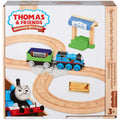 Image of a boxed Fisher-Price Thomas & Friends Wooden Railway Figure 8 Track Pack, perfect for preschool kids. The set includes a figure-eight wooden track, a blue train resembling Thomas, a station, and wooden cargo pieces. The colorful box features Thomas & Friends branding and is marked for ages 3 and up.